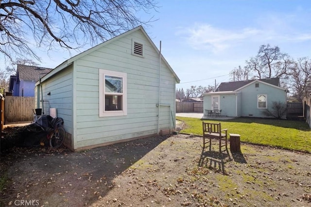 rear view of house with a patio area and a lawn