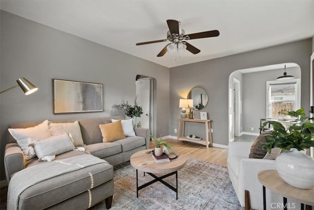 living room featuring light wood-type flooring and ceiling fan