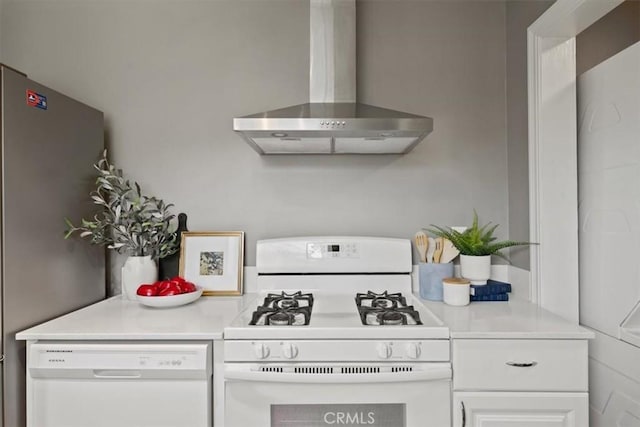 kitchen with white cabinets, wall chimney exhaust hood, and white appliances