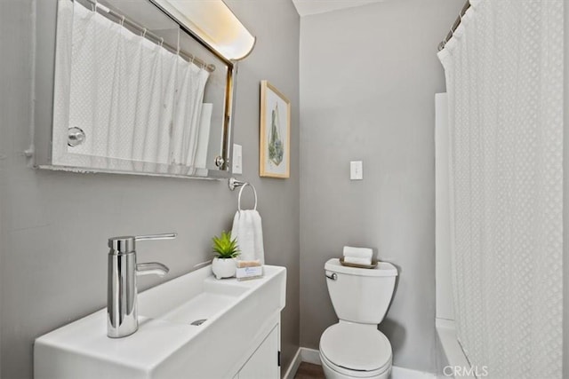 bathroom featuring toilet, a shower with curtain, and vanity