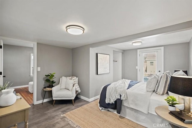 bedroom with dark hardwood / wood-style floors