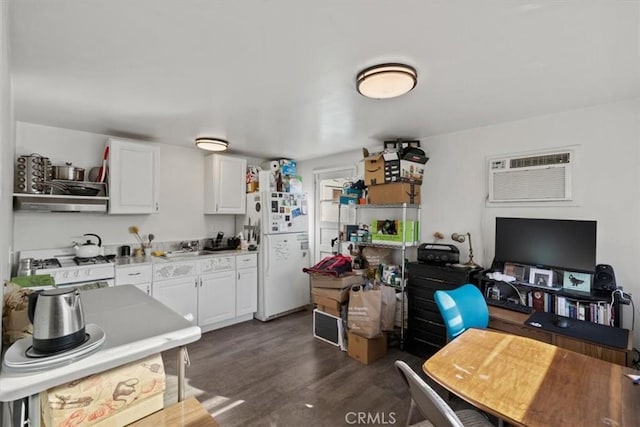 kitchen featuring white cabinets, white refrigerator, dark hardwood / wood-style flooring, and a wall mounted AC