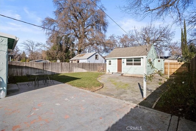 rear view of house with a yard, a patio area, and an outdoor structure