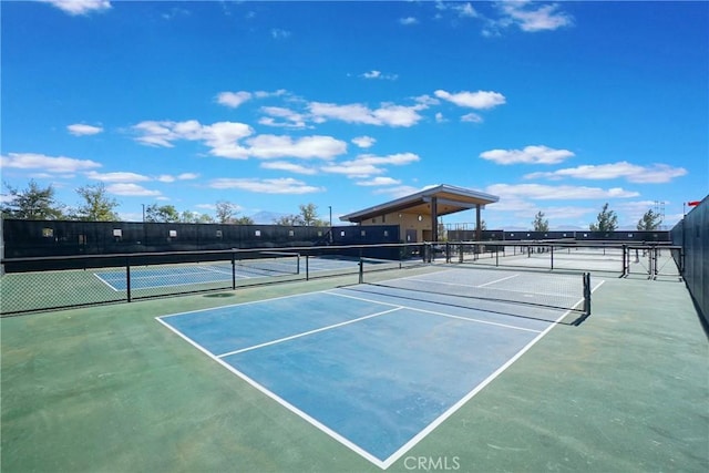 view of tennis court featuring basketball hoop