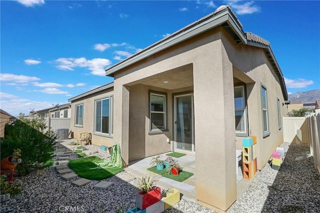 back of house featuring central air condition unit and a patio