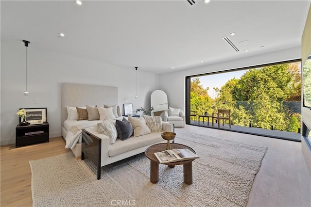 bedroom with access to outside and light hardwood / wood-style floors