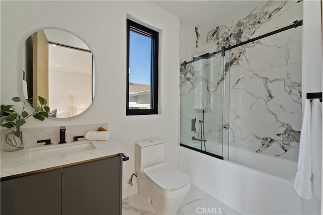 full bathroom featuring toilet, vanity, and tiled shower / bath combo