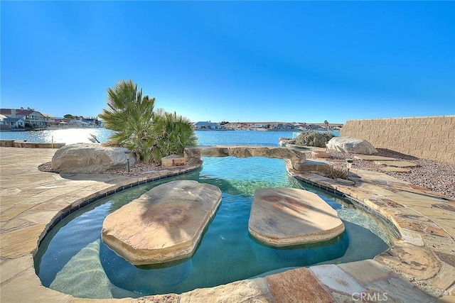 view of swimming pool with a water view