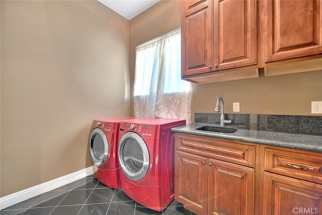 laundry area featuring cabinets, sink, washer and clothes dryer, and dark tile patterned floors