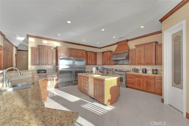 kitchen featuring tasteful backsplash, a kitchen island, sink, wall chimney exhaust hood, and high quality appliances