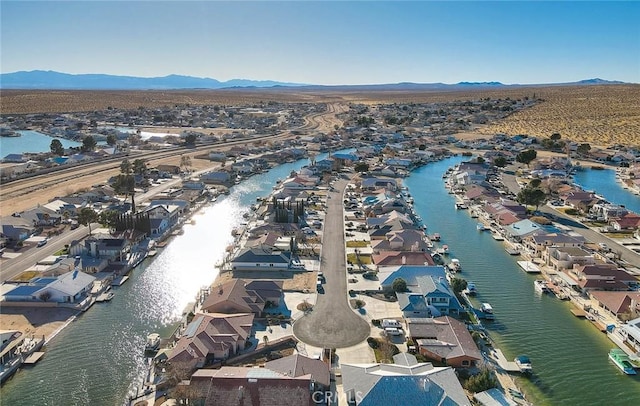 birds eye view of property with a water and mountain view