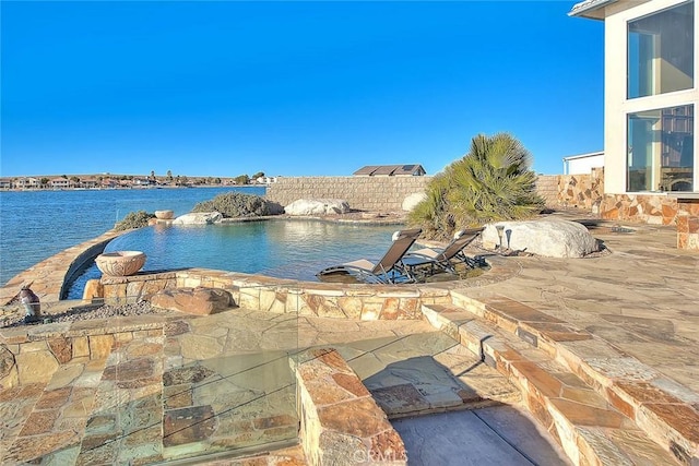 exterior space with a fenced in pool and a water view