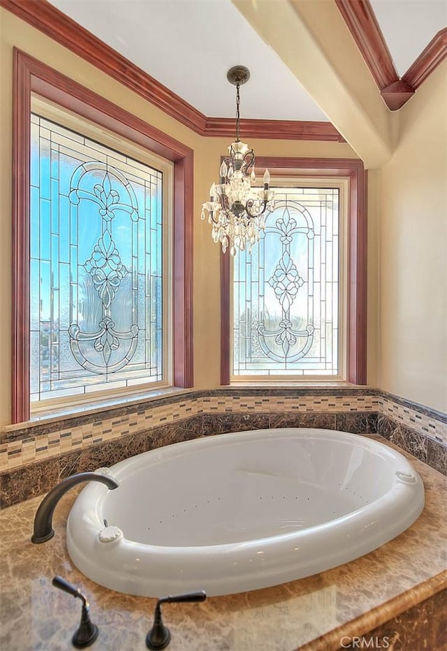 bathroom featuring a chandelier and crown molding