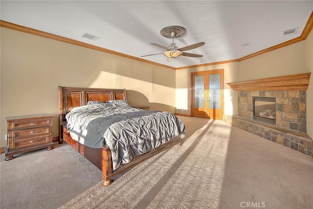 carpeted bedroom featuring ceiling fan, french doors, a textured ceiling, and ornamental molding