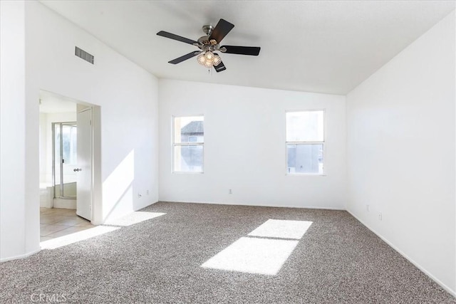 carpeted empty room featuring ceiling fan and lofted ceiling