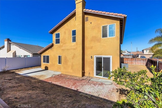 rear view of property featuring a patio