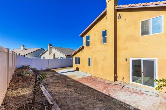 back of house with a patio