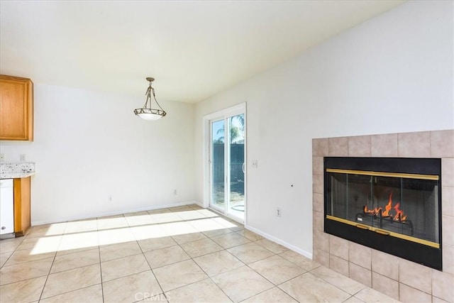 unfurnished dining area featuring light tile patterned floors, a fireplace, and a wealth of natural light