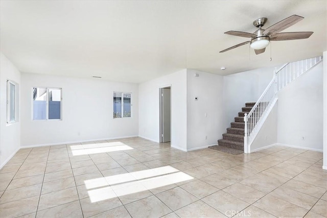 tiled empty room featuring ceiling fan