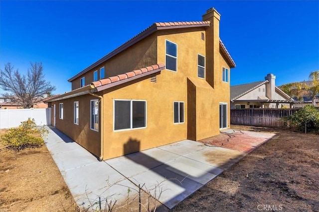 back of house with a patio