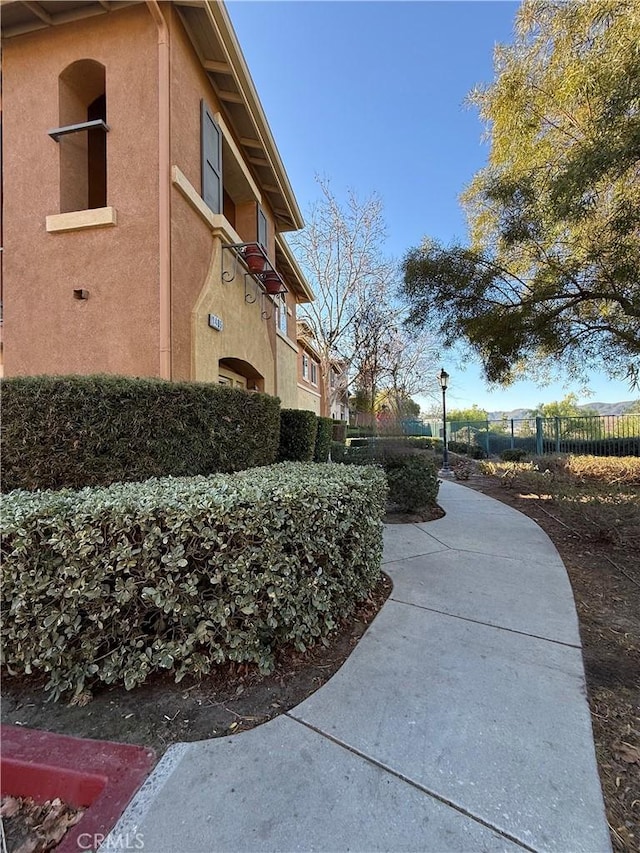 view of home's exterior featuring fence and stucco siding