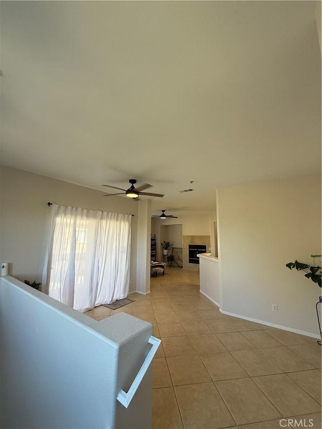 corridor featuring light tile patterned floors and baseboards