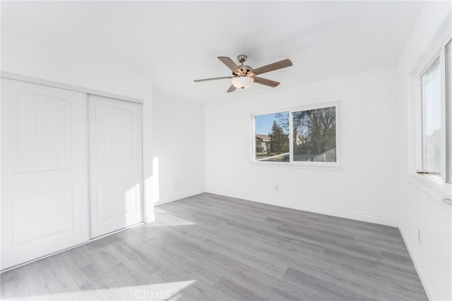 unfurnished room featuring ceiling fan and light wood-type flooring