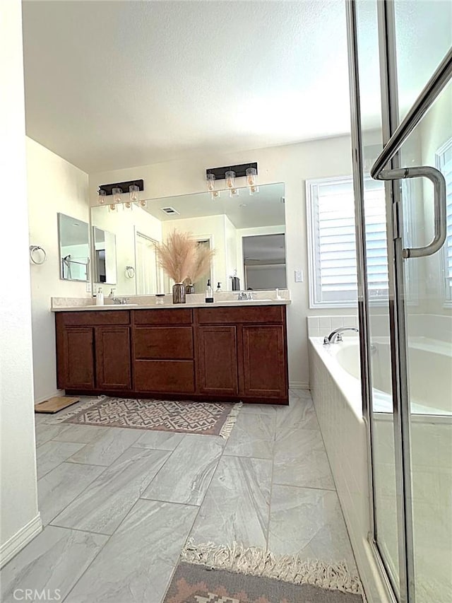 bathroom featuring independent shower and bath and vanity