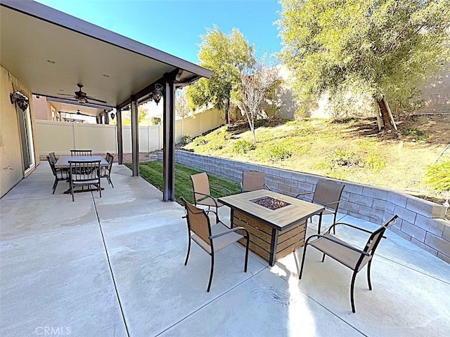 view of patio / terrace featuring ceiling fan and an outdoor fire pit