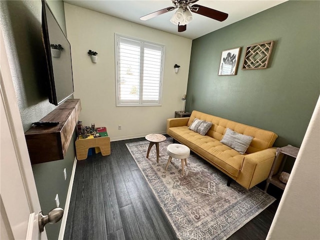 living room with dark wood-type flooring and ceiling fan