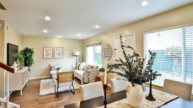 dining space with hardwood / wood-style floors