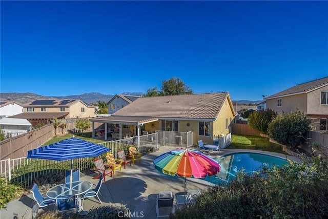 view of swimming pool featuring a patio area and a mountain view