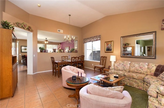 living room with light tile patterned flooring, lofted ceiling, and ceiling fan with notable chandelier