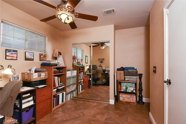 office featuring ceiling fan and dark parquet floors