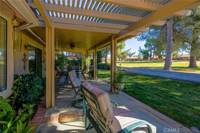 view of patio / terrace with ceiling fan and a pergola