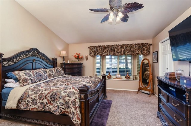 carpeted bedroom featuring vaulted ceiling and ceiling fan