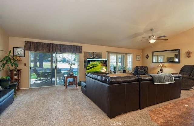 carpeted living room featuring ceiling fan and lofted ceiling