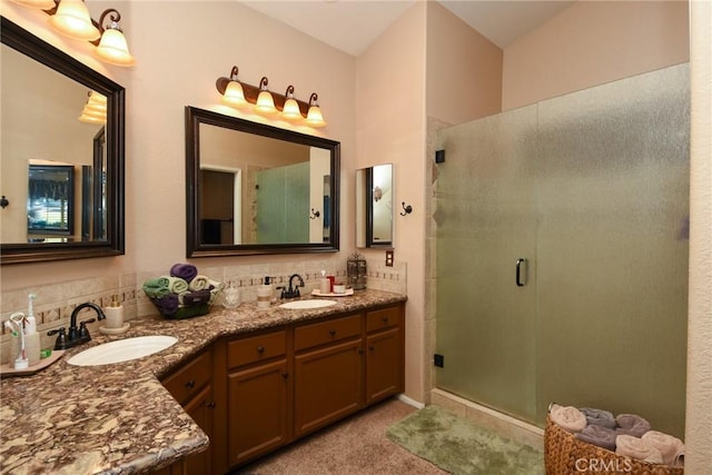 bathroom featuring walk in shower, vanity, and backsplash