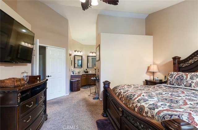 bedroom featuring ceiling fan, light carpet, and connected bathroom