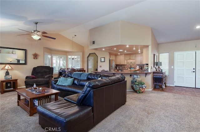 living room featuring vaulted ceiling, carpet, and ceiling fan with notable chandelier