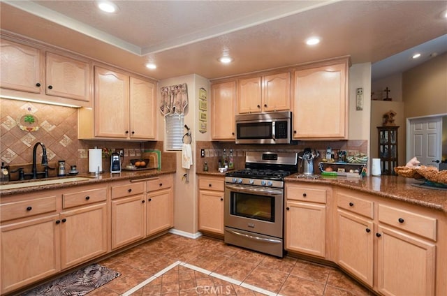 kitchen featuring tile patterned floors, sink, light brown cabinets, and stainless steel appliances