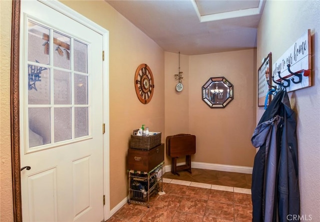 doorway to outside with dark tile patterned floors