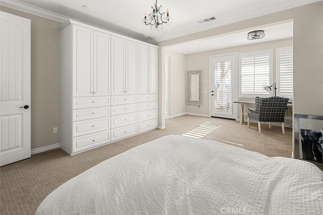 carpeted bedroom with ornamental molding and a notable chandelier