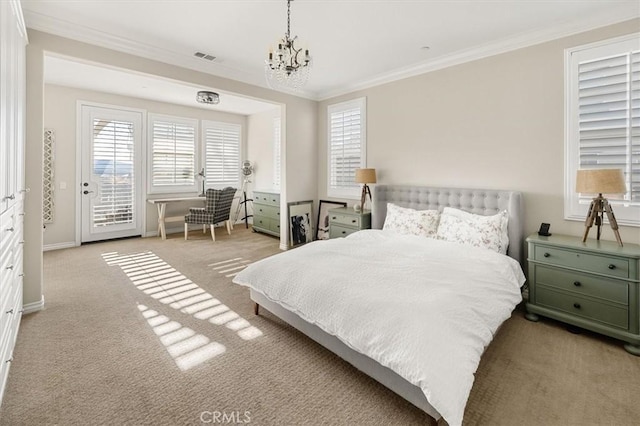 carpeted bedroom with access to exterior, crown molding, and an inviting chandelier