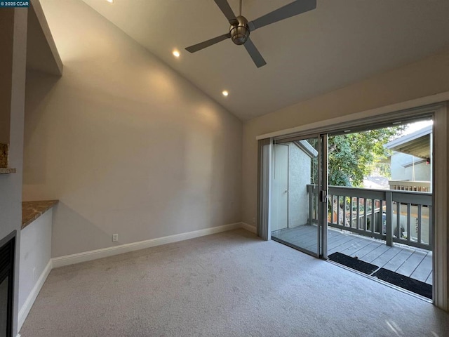 interior space with ceiling fan, light carpet, a fireplace, and high vaulted ceiling