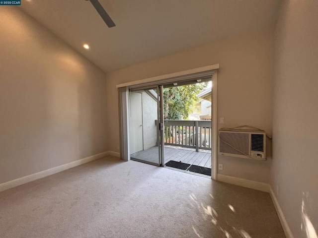 carpeted empty room featuring a wall mounted AC and lofted ceiling