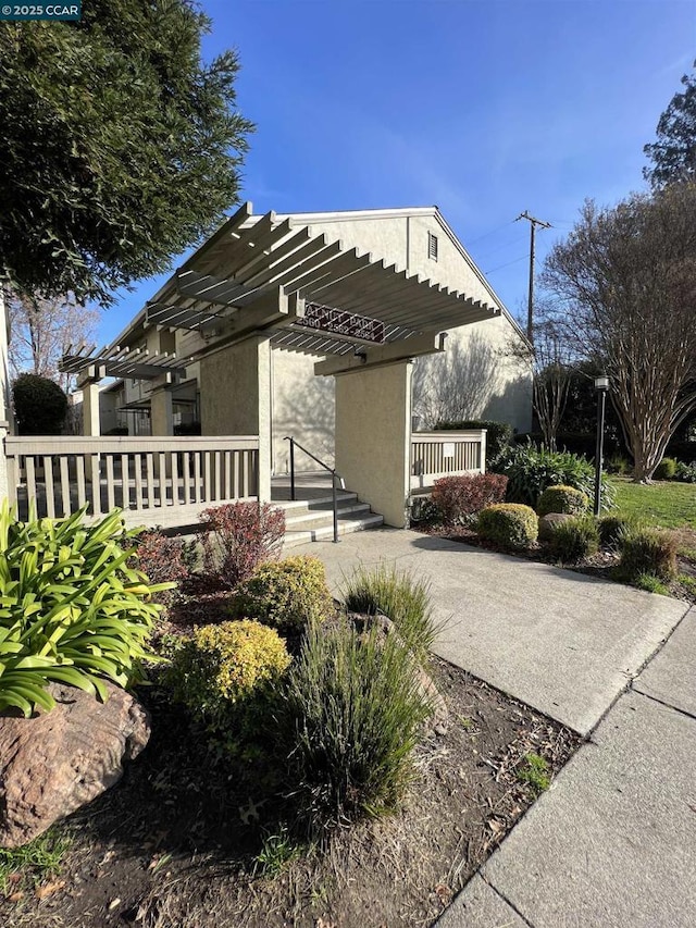 view of home's exterior with a pergola