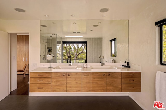 bathroom with an enclosed shower and vanity