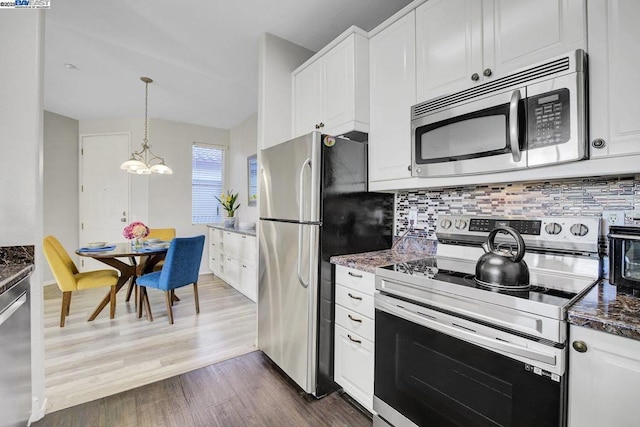 kitchen featuring appliances with stainless steel finishes, white cabinetry, an inviting chandelier, decorative backsplash, and dark hardwood / wood-style floors