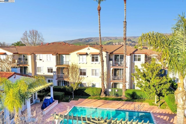 view of swimming pool with a pergola, a mountain view, and a patio